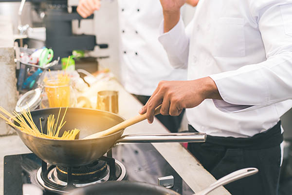 Chef preparing food in the kitchen of a restaurant